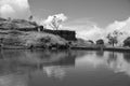 Monochromatic beautiful landscape with lake on the top of a mountain with entrance and sky covered in clouds