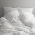 Monochromatic comfort White bedding in disarray, black and white tones