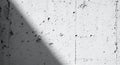 Monochromatic concrete wall with strong diagonal shadow, rugged texture and subtle cracks creating an urban backdrop Royalty Free Stock Photo