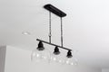 Monochromatic Farmhouse Modern Light Fixture with Glass Shades and Recessed Lighting