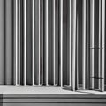 A monochromatic image of architectural elements casting abstract shadows on a minimalist structure3, Generative AI
