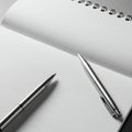 A monochromatic image featuring an open spiral-bound notebook with pristine white Royalty Free Stock Photo