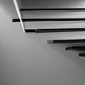 A monochromatic image of light and shadow on a staircase, creating an abstract play of depth and contrast3, Generative AI