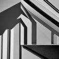 A monochromatic image of light and shadow on a staircase, creating an abstract play of depth and contrast4, Generative AI