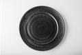 Monochromatic image. Top view of a black pastel plate on a pastel white background. Minimalism food photography. Geometric style.