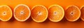 A monochromatic orange palette, Bright orange halves and leaves on a vivid orange background Royalty Free Stock Photo