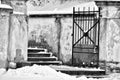 monochromatic scene of an old, weathered gate and wall covered in snow, conveying a sense of solitude and the passage of time, Royalty Free Stock Photo