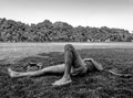 Young male skater resting on the grass with his eyes closed