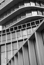 Monochrome architecture, curved lines of a modern building facade, pattern of windows and balconies,