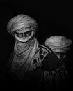 Monochrome artistic lowkey portrait of a Sahara inhabitant, traditional clothing