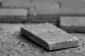 Black and white background with broken paving stones is close, soft focus