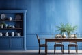 Monochrome blue kitchen interior with wood table in rustic style. Textured empty blank wall. Background for mockup