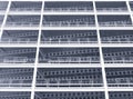 Monochrome blue tinted looking upwards view of large modern commercial building under construction with steel beams and girders Royalty Free Stock Photo