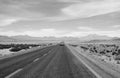Monochrome of a Car Driving on the Desert Road of Northern Chile, South America Royalty Free Stock Photo