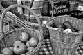 Monochrome closeup shot of baskets filled with big sweet apples in the farmer\'s market