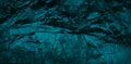 Blue rocky stone background. Monochrome dark turquoise toned rock texture. Weathered crumbling mountain surface. Close-up. Royalty Free Stock Photo