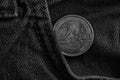 Monochrome Euro coin with a denomination of two euro in the pocket of old vintage blue denim jeans Royalty Free Stock Photo