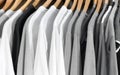 Monochrome Fashion Essentials: White, Gray, and Black T-Shirts Hanging on a Hanger, Offering Versatile Wardrobe Choices Royalty Free Stock Photo