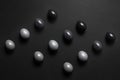 Monochrome gradient Easter eggs lie in a row on a black background, top view Royalty Free Stock Photo