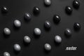 Monochrome gradient Easter eggs lie in a row on a black background, top view with text Royalty Free Stock Photo