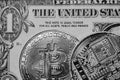 Monochrome image of Bitcoin crypto currency seen laying on a regular One Dollar banknote.