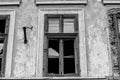 Monochrome image ,broken windows on old abandoned residentual house