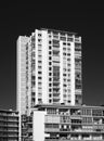 Monochrome image of 1970 concrete apartment block and tower with balconies
