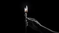 Monochrome image of a flame, hand holding a burning candle flame effect, hand holding a burning match on dark backdrop Royalty Free Stock Photo