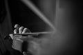 Monochrome image of male hand playing music on a classical violin Royalty Free Stock Photo