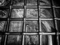Monochrome image old metal prison type bars on a dark old empty cell like space Royalty Free Stock Photo