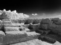 Monochrome image of old ruined quarry workings carved out in geometric shapes