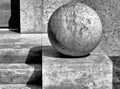 Monochrome isolated stone sphere on cube pedestal. stone stair.