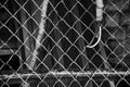 Monochrome metal mesh fence and corrugated hose with wire Royalty Free Stock Photo