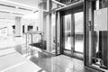 monochrome Modern steel elevator doors cabins in a business lobby or Hotel, Store, interior, office,perspective wide angle. Three Royalty Free Stock Photo