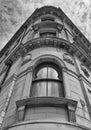 Monochrome perspective view of a 19th century tall stone neoclassical building with ornate curved windows in the little germany Royalty Free Stock Photo