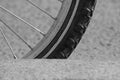 Monochrome photo of a bicycle wheel is close