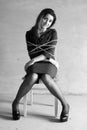 Monochrome photo of a business woman sitting on chair associated