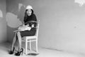 Monochrome photo of a business woman sitting on chair associated