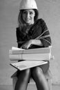 Monochrome photo of a business woman sitting on chair associated