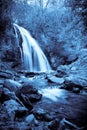 Monochrome photo of a mystical small waterfall