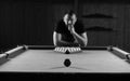 Monochrome photo young man playing billiards Royalty Free Stock Photo