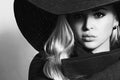 Monochrome portrait of Beautiful Blond Woman in Black Hat. Fashionable Lady in Topcoat Royalty Free Stock Photo