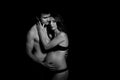 Monochrome portrait of happy loving couple in a moment of love and tenderness. Pregnant woman with hands over tummy. Royalty Free Stock Photo