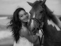 Monochrome. Portrait of smiling woman and horse. Woman hugging horse. Romantic concept. Love to animals. Black-white photo. Nature Royalty Free Stock Photo