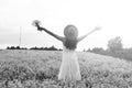 monochrome portrait of young girl in a hat standing in a huge fi Royalty Free Stock Photo