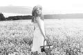 monochrome portrait of young girl in a hat standing in a huge fi