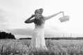 monochrome portrait of young girl in a hat standing in a huge fi Royalty Free Stock Photo