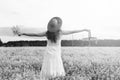 monochrome portrait of young girl in a hat standing in a huge fi Royalty Free Stock Photo