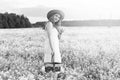 monochrome portrait of young girl in a hat standing in a huge fi