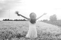 monochrome portrait of young girl in a hat standing in a huge fi